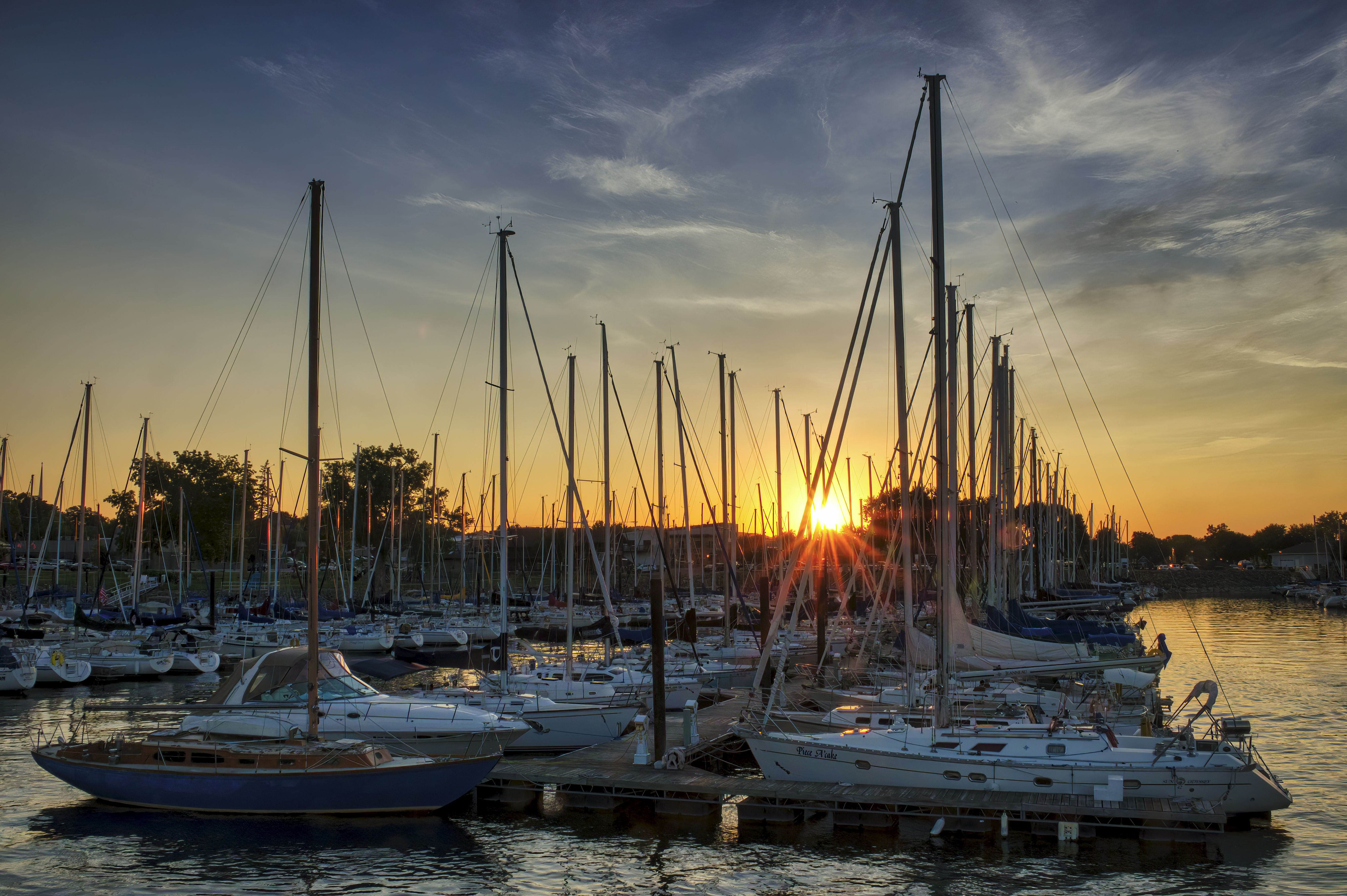 Sailboats at a marina during golden hour